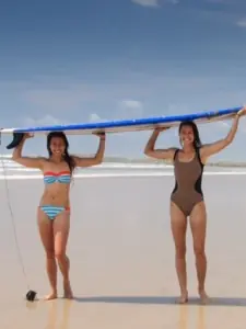 two women holding a board