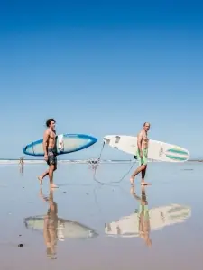 two men and two surfboards