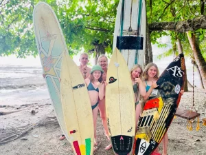 family on the beach with surfboards