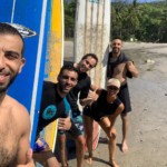 This is a nice photo! Algerian males with surfboards at Santa Teresa Beach.
