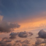The grey color gives pass to the orange and blue in the sky Gray clouds disperse in Santa Teresa.